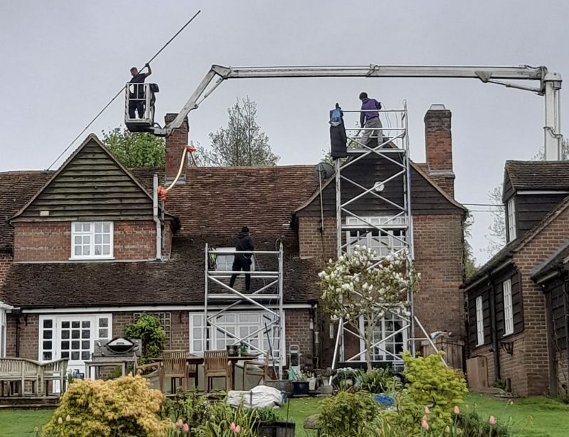 The Moss Cleaners using cherry picker and scaffolding to clean roof safely and professionally in Bulford, Wiltshire